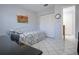 A bedroom with a daybed, tiled floors, neutral walls, and closet doors, maximizing space at 5970 80Th Street North # 206, St Petersburg, FL 33709