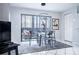 Cozy dining area with a glass table, modern chairs, and natural light from the sliding glass doors at 5970 80Th Street North # 206, St Petersburg, FL 33709