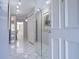 Bright entryway featuring white tile floors, an arched mirror, and a view into the dining area at 5970 80Th Street North # 206, St Petersburg, FL 33709