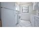 All-white kitchen featuring a range, microwave, refrigerator and tile floor at 5970 80Th Street North # 206, St Petersburg, FL 33709