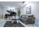 Modern living room with a grand piano, sleek furniture, and stylish decor at 5970 80Th Street North # 206, St Petersburg, FL 33709