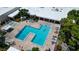 Aerial view of the pool and patio area featuring lounge chairs and tables at 5970 80Th Street North # 206, St Petersburg, FL 33709