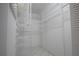 Spacious walk-in closet with white shelving, racks, and tile flooring at 5970 80Th Street North # 206, St Petersburg, FL 33709