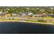 Scenic aerial view of waterfront homes featuring manicured landscaping, trees, and street at 723 S Brevard Ave, Tampa, FL 33606
