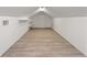 Finished attic with neutral flooring and walls, with shelves, lighting and ventilation at 723 S Brevard Ave, Tampa, FL 33606