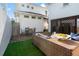 Inviting backyard with outdoor seating, lush artificial turf, and a mix of sunny and shaded areas at 723 S Brevard Ave, Tampa, FL 33606