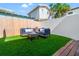 Backyard with artificial turf and wooden deck, ideal for outdoor seating and relaxation at 723 S Brevard Ave, Tampa, FL 33606