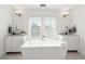 Bright bathroom featuring a modern soaking tub, double vanities, and ample natural light at 723 S Brevard Ave, Tampa, FL 33606