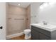 Bathroom with a tiled walk-in shower, modern vanity, and wood floors at 723 S Brevard Ave, Tampa, FL 33606