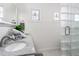 Bright bathroom features a tiled shower and a granite countertop sink with a large mirror at 723 S Brevard Ave, Tampa, FL 33606