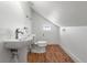 Small bathroom with wood look floors, stained glass window and modern pedestal sink at 723 S Brevard Ave, Tampa, FL 33606