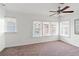 Bright bedroom with three windows providing ample light, neutral walls, and a ceiling fan at 723 S Brevard Ave, Tampa, FL 33606