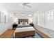 Bedroom with a wooden bed frame, nightstands, lamps, and windows with natural light at 723 S Brevard Ave, Tampa, FL 33606
