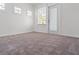 Bright room featuring carpet, two small windows and a glass door with blinds at 723 S Brevard Ave, Tampa, FL 33606