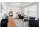 Bright room with wood floor, ceiling fan, gray chairs, and windows with natural light at 723 S Brevard Ave, Tampa, FL 33606
