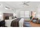 Spacious bedroom featuring wood floor, ceiling fan, a large bed and natural light at 723 S Brevard Ave, Tampa, FL 33606
