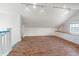 Finished attic space with wood floors, a railing, and windows with water view at 723 S Brevard Ave, Tampa, FL 33606