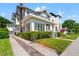 Charming two-story home with a well-manicured lawn, brick driveway, and welcoming front porch at 723 S Brevard Ave, Tampa, FL 33606
