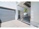 Exterior view of home with garage, side entry and steps leading to the front porch at 723 S Brevard Ave, Tampa, FL 33606
