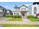 Inviting two-story home showcasing a red front door, manicured lawn, and classic design at 723 S Brevard Ave, Tampa, FL 33606
