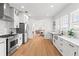 Well-lit kitchen boasts white cabinets, stainless steel appliances, and marble countertops at 723 S Brevard Ave, Tampa, FL 33606