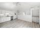 Bright open kitchen with stainless steel appliances, white cabinetry, and wood flooring at 723 S Brevard Ave, Tampa, FL 33606