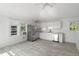 Bright kitchen with white cabinets, stainless steel appliances, and hardwood floors at 723 S Brevard Ave, Tampa, FL 33606