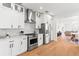 Modern kitchen with stainless steel appliances, white cabinets, and wooden floors at 723 S Brevard Ave, Tampa, FL 33606