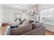 Cozy living room featuring a whitewashed brick fireplace, plush seating, and natural light at 723 S Brevard Ave, Tampa, FL 33606
