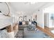 Bright living room with white brick fireplace, hardwood floors, and comfortable grey sofa at 723 S Brevard Ave, Tampa, FL 33606