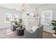 Bright living room featuring two gray chairs, a ottoman, and a fireplace at 723 S Brevard Ave, Tampa, FL 33606