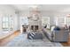 Bright living room featuring a decorative fireplace, neutral-toned furniture, and hardwood floors at 723 S Brevard Ave, Tampa, FL 33606
