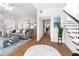 Open-concept living room with hardwood floors and a staircase leading to upper level at 723 S Brevard Ave, Tampa, FL 33606