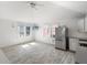 Bright living area with stainless steel refrigerator, ceiling fan, and natural lighting at 723 S Brevard Ave, Tampa, FL 33606