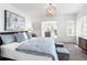 Spacious main bedroom with a plush bed, soft lighting, and a glimpse into an adjoining room at 723 S Brevard Ave, Tampa, FL 33606