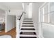 Bright staircase with wooden steps and white risers, complemented by a large window letting in natural light at 723 S Brevard Ave, Tampa, FL 33606