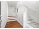 Interior stairway with wooden floors and handrails; leading up to a bright and airy space at 723 S Brevard Ave, Tampa, FL 33606