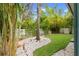 Lush tropical landscaping surrounds the artificial turf backyard at 7513 S Sparkman St, Tampa, FL 33616