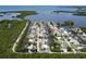 Aerial view showcasing a waterfront neighborhood, with canals leading to open water and private boat access at 832 Seabreeze Dr, Ruskin, FL 33570