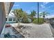 View of the backyard with a rock garden and canal front in a waterfront neighborhood at 832 Seabreeze Dr, Ruskin, FL 33570