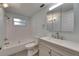 Bathroom featuring neutral walls, tiled shower/tub combo, and a gray vanity with white countertop at 832 Seabreeze Dr, Ruskin, FL 33570