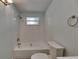 Bathroom featuring tiled shower/tub combo, neutral walls and tile flooring, and updated fixtures at 832 Seabreeze Dr, Ruskin, FL 33570