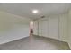 Bedroom featuring neutral walls, wood-look tile flooring, a large closet and bathroom access at 832 Seabreeze Dr, Ruskin, FL 33570