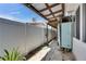 The side of the house has an outdoor shower and walkway to backyard at 832 Seabreeze Dr, Ruskin, FL 33570