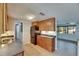 Kitchen showcasing wood cabinets, tile flooring, and stainless steel refrigerator at 832 Seabreeze Dr, Ruskin, FL 33570