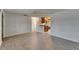 Open-concept living room with wood-look tile flooring, neutral paint, and a view into the kitchen at 832 Seabreeze Dr, Ruskin, FL 33570