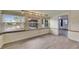 Bright living room with wood-look tile floors and natural light from three large windows at 832 Seabreeze Dr, Ruskin, FL 33570