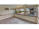 Bright living room with wood-look tile floors and natural light from three large windows at 832 Seabreeze Dr, Ruskin, FL 33570