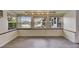 Bright living room with wood-look tile floors and natural light from three large windows at 832 Seabreeze Dr, Ruskin, FL 33570