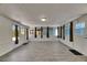 Spacious living room featuring tile floors, natural light, and multiple entry points at 832 Seabreeze Dr, Ruskin, FL 33570